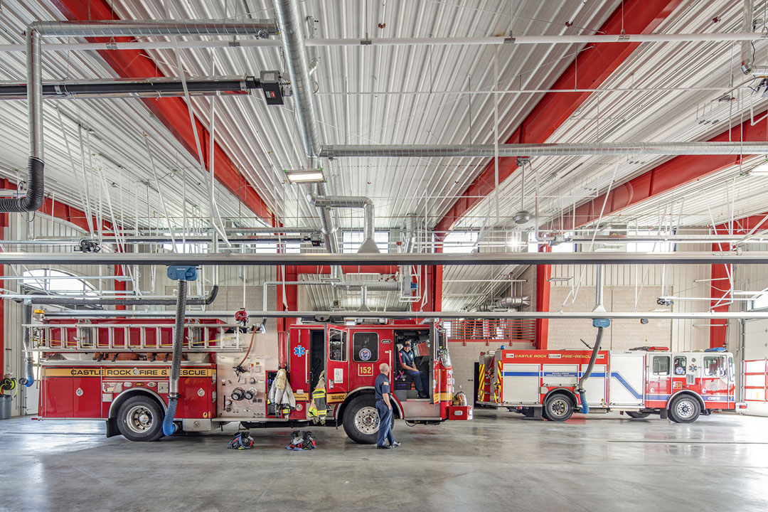 Castle Rock Fire Station interior equipment bay with trucks